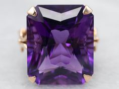 This beautiful vintage setting has a timeless feel, with curling textured motifs along the shoulders. Set in the center is a stunning emerald-cut amethyst of the deepest shade of plum and lilac reflecting light to and from the golden frame.Metal: 14K Yellow GoldGem: Amethyst 14.61 Carats Gem Measurements: 16.8 x 13.9 mm, Cushion Cut Ring Size: 5.75Marks: “14K T.Y.L” Stamped on the inside band Yellow Gold Amethyst Ring, Vintage Setting, Gold Amethyst Ring, Reflecting Light, Golden Frame, Cushion Cut Ring, Amethyst Ring, Cushion Cut, Emerald Cut