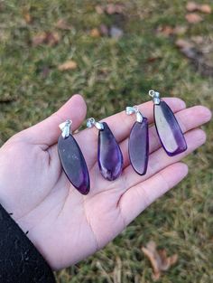 These dark purple amethyst pendants are prefect for either a DIY project, or to wear by itself as a simple necklace.  Each one measures between 1.5 to 1.75 inches long, and comes with a metal bail already attached.  A black cord with lobster clasp is available for free if you would like - just let me know when you place the order.  These are natural stones, so please understand there may be slight flaws. ----- About us: We are a couple of besties sharing our mutual loves of bones, crystals, and plants. Everything in the shop is either handmade or hand-selected with intent.  We do not use filters on any of our photos! We do choose the lighting (indoor, outdoor, time of day) that will highlight the item best, but everything we photograph is taken without filters, and will be clearly labeled Purple Amethyst Pendant Crystal Necklace, Purple Gemstone Crystal Pendant Necklace, Faceted Amethyst Pendant Crystal Necklace, Purple Necklace With Large Pendant, Purple Pendant Necklace With Large Pendant, Purple Necklace With Large Round Pendant, Amethyst Pendant For Jewelry Making, Amethyst Crystal Pendant Gift, Spiritual Purple Jewelry With Large Pendant