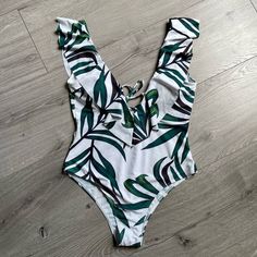 Nwot Zaful Leaf Print Ruffle Plunging Swimsuit In Size L. Give Yourself A Fun Summer Look With This Vibrant Leaf Print One-Piece Swimsuit. The Low Collarline And Low Back Are Decorated With Sweet Ruffles That Add A Little Chic To Your Sunny Days. Better Fit For Women With Smaller Breast. Never Worn. No Original Tags. Bra Style: Padded Support Type: Wire Free Collar-Line: Plunging Collar Pattern Type: Leaf Decoration: Ruffles White Summer One Piece With Ruffles, White Summer One-piece With Ruffles, White Ruffled One-piece Swimsuit, White Ruffled One-piece For Summer, White Ruffled Summer One Piece, White Ruffled Summer One-piece, White Ruffled One Pieces For Summer, White Ruffled One-piece For Beach Season, White Ruffled One-piece Swimwear