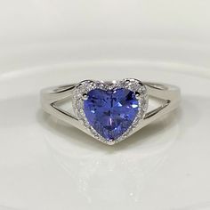 Vintage Sterling Silver Tanzanite & White Topaz Heart Ring ...Marked 925...Total of weights 3.2gramsMeasure of Stone center 6.5MM...Measure of Face 9.2MM....It's in very good condition. Heart Cut Tanzanite Jewelry For Anniversary, Heart Cut Tanzanite Jewelry Gift, Heart Shaped Sapphire Rings For Formal Occasions, Anniversary Heart Cut Topaz Ring In Sterling Silver, Formal Sapphire Heart-shaped Rings, Silver Sapphire Heart Cut Ring, Silver Heart Cut Sapphire Gemstone Ring, Sapphire Rings For Valentine's Day, Silver Heart Cut Gemstone Birthstone Ring