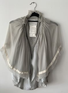 "Beautiful deconstructed cardigan/ shrug by Sacai. Raw edged silk georgette creates soft wing shaped drape over button front cardigan base.  Perfect to pop over a dress or tee and add a fun ethereal movement to your look. Unusual and unique piece. Fits a Size Small - Easy throw on fit. Measurements: Front Body - 22\" Back Body Length - 17\" Great condition, barely worn." Sweater Deconstruction, Deconstructed Knit Sweater, Avant-garde Asymmetrical Fitted Outerwear, Deconstructed Knitwear, Sacai Deconstruction, Shrug Cardigan, Button Front Cardigan, Sweater Outfits, Unique Pieces