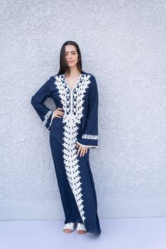 "A stunning embroidered Kaftan dress that is elegant, colorful, and unique! The dress is made of Egyptian cotton that has a soft feel to it so you will surely feel comfortable and royal in it. It also comes with a small invisible pocket on the right side of the Kaftan for added practicality. You can wear this Kaftan practically anywhere and for any occasion. You can dress it up with a pair of heels and strut like an Egyptian queen in any gathering, resort, or party. Or you can dress it down with Traditional Long Sleeve Maxi Dress With Resham Embroidery, Bohemian Dresses With Dabka Work, Eid Tunic Dress With Resham Embroidery, Bohemian Embroidered Dress With Dabka Work, Festive Long Sleeve Maxi Dress With Chikankari Embroidery, Traditional Long Sleeve Dress With Embroidered Border, Traditional Long Sleeve Maxi Dress With Multicolor Embroidery, Bohemian V-neck Kurta With Intricate Embroidery, Traditional Floor-length Kaftan With Embroidered Border