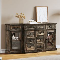 an old wooden sideboard with glass doors and drawers in a room next to a white rug