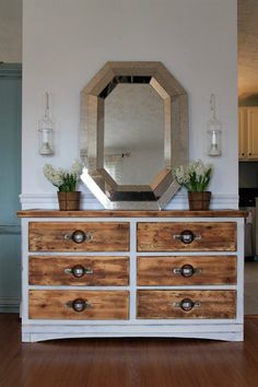 a dresser with drawers and a mirror on top