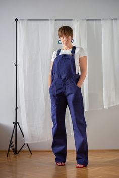 "Your dream vintage denim chore overalls in indigo blue. 100% cotton German workwear from the 1970s in pristine condition, the highest quality I have seen so far! Starting from the high quality, sturdy, durable fabric through the perfect stitches to the stunning label on the inside, it is a perfect piece. It features straight leg and high waist. It is elevated with a number of pockets: large side patch pockets, one pocket at thigh height, one back pocket and a patch and a zip pocket on the bib. Blue Utility Overalls With Straight Leg, Blue Utility Straight Leg Overalls, Blue Straight Leg Utility Overalls, Workwear Bib Front Jeans With Pockets, Workwear Jeans With Bib Front And Pockets, Workwear Bib Front Jeans, Dark Wash Cotton Cargo Pants, Relaxed Fit Cotton Overalls With Straight Leg, Denim Blue Cotton Overalls