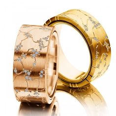 two gold rings with diamonds on them