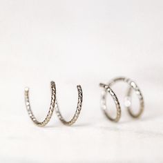 Tiny Double Hoop Earrings, Minimal Spiral Earrings, Tiny Twist Earrings, Double Hoop Earrings, Double Piercing, Diamond Cut Hoop EarringsTwist these little coils in and instantly get the appearance of two lobe piercings.(You only need ONE piercing to make these work-- they give the look of two!)(It can also be worn with two holes in case you have them)All you do is thread one side through your first hoop until the other side sits comfortably on your earlobe giving the illusion of a second hole. Twist Earrings, Lobe Piercings, Double Piercing, Earrings Minimal, Earrings Double, Double Hoop Earrings, Lobe Piercing, Open Hoop Earrings, International Jewelry