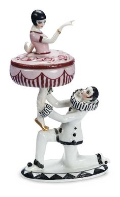 a ceramic figurine with a man holding a tray on his head and another person reaching for it