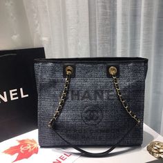 Description CC Deauville Chain Shoulder Tote Bag Dark Grey For Women, Women’s Handbags, Shoulder Bags 13.3in/34cm A66939 Rep 1:1 Measurements: 34 x 18 x 25 cm / 13.3 x 7 x 9.8 inches (Length x Width x Height) This tote bag is made by one of the finest brands in the country, CC and it has an excellent storage capacity with an elegant color. It also has a cotton canvas material which is durable, zipper pocket, an open pocket and a mobile pocket. Glance your eyes on the lettering: ‘CC CC 31 Rue Cam 31 Rue Cambon, Louis Vuitton Shirt, Bag Dark, Elegant Color, Luxury Products, Evening Clutch Bag, Shoulder Tote Bag, Grey And Gold, Tote Backpack