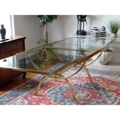 a glass table with metal legs in a living room