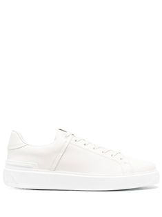 low-top leather sneakers from Balmain featuring ecru, calf leather, round toe, front lace-up fastening, logo patch at the tongue, flat rubber sole and logo at the sole. | Balmain Low-Top Leather Sneakers Mini Logos, Low Top, Sneakers White, Front Row, White Sneaker, Converse Sneaker, Leather Sneakers, Patch Logo, Calf Leather