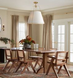 a dining room table with four chairs around it