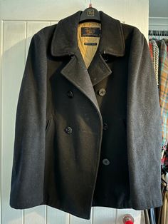 This J.CREW BAYSWATER PEA COAT is the perfect addition to any man's wardrobe. Made with thick black wool, this coat is warm and stylish. The military-grade construction ensures durability and longevity. The coat is a size M and has a regular fit. The black color is versatile and can be dressed up or down. The pea coat style is timeless and will never go out of fashion. This coat is perfect for winter weather and will keep you warm and stylish for years to come. Excellent gently used condition. S Winter Black Single-breasted Peacoat, Black Long Peacoat With Pockets, Classic Black Pea Coat For Winter, Black Wool Coat For Winter, Black Winter Peacoat For Cold Weather, Black Peacoat With Pockets For Cold Weather, Wool Pea Coat For Cold Weather, Black Wool Pea Coat For Work, Black Wool Pea Coat For Winter