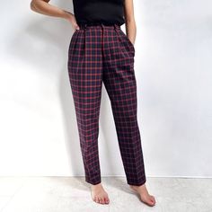 Gorgeous, classy, vintage Lacoste golfing ladies trousers in navy and red tartan pattern. They have a peg leg, high waist with pleats, side pockets, back pocket, belt loops and a zip and button fastening. The trousers are made from a quality wool mix fabric and are partially lined. Perfect for a relaxed smart style, but can also be dressed up. Made by Lacoste. 53% polyester, 44% wool, 3% elastane. 100% polyester lining. Labelled as 40, would fit a Medium size. Measurements when laid flat are: Wa Tailored Plaid Casual Bottoms, Plaid Workwear Bottoms With Belt Loops, Preppy Fitted High-waist Bottoms, Preppy High Waist Fitted Bottoms, Preppy Fitted High Waist Bottoms, Preppy High-waisted Fitted Bottoms, Fitted Pleated Plaid Bottoms, Vintage Plaid Bottoms For Work, Fitted Plaid Bottoms For Workwear