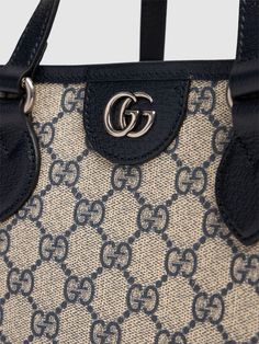 Find GUCCI Ophidia Canvas Tote Bag on Editorialist. The GUCCI Ophidia Canvas Tote Bag is crafted from beige and ebony GG supreme canvas. The bag features a double top handle, a fixed strap, and a logo detail. The tote measures 25cm in height, 31cm in width, and 13cm in depth. The handle drop measures 13.5cm, while the strap drop measures 29cm. Blue Monogram Canvas Bag With Detachable Handle, Blue Monogram Canvas Shoulder Bag With Handles, Luxury Blue Canvas Shoulder Bag, Gucci Canvas Bags With Gold-tone Hardware, Blue Luxury Monogram Canvas Shoulder Bag, Luxury Blue Canvas Bag, Luxury Canvas Bag With Gold-tone Hardware, Blue Monogram Canvas Shoulder Bag With Leather Handles, Gucci Monogram Canvas Shoulder Bag With Top Carry Handle