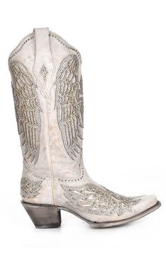 Introducing the Corral Women's Wing & Cross Studded Wedding Boots - the ultimate statement piece for brides who dare to be different. These exquisite white boots are designed to elevate your wedding style, taking you beyond the traditional and into a realm of bold, modern chic. Crafted from premium white leather, these wedding boots showcase an intricate wing and cross design brought to life by a stunning white glitter overlay. The silver studs sprinkled throughout the design exude sophisticatio Wedding Dress Cowboy Boots, Bridal Cowboy Boots, White Wedding Boots, Bride Boots, Glitter Overlay, Dresses With Cowboy Boots, Country Theme Wedding, Contemporary Bride, Wedding Boots