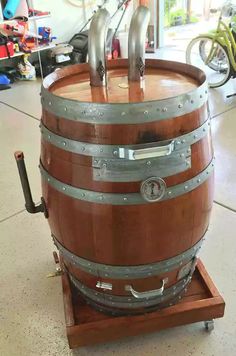 a large wooden barrel sitting on top of a cart in a room filled with bikes