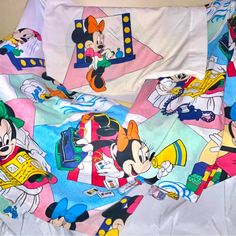 the mickey mouse sheets are laying on top of each other