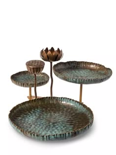 three metal trays with two flowers on each side and one flower in the middle