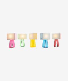 four different colored lamps sitting next to each other