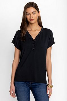 Crafted from a super soft modal blend with a hint of stretch, the Modal Jersey Button Neck Tee offers a modern take on classic sportswear. Featuring a curved V-neckline with decorative buttons, this short sleeve tee creates a relaxed fit with a custom feel. Pair with linen shorts and fashion sneakers to take on the warmest days. Johnny Was Women's Modal Jersey Button Neck T-Shirt in Black Beauty White, Size Small, Linen Casual Viscose Tops With Shirttail Hem, Solid Henley Neckline Tops For Everyday, Relaxed Fit Henley Neckline Tops For Loungewear, Casual Stretch Top With Henley Neckline, Casual Henley Neckline Tops With Stretch, Stretch Henley Neckline Top For Loungewear, Casual Henley Neckline Tops For Loungewear, Casual Modal Top With Relaxed Fit, Casual Modal Tops For Everyday