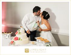 a bride and groom kissing in front of a wedding cake with donuts on the table