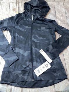 Reebok Women’s Small Black Camo Hooded Zip Up Jacket NEW. Hooded Techwear Activewear For Fall, Fall Workout Hooded Jacket With Adjustable Hood, Urban Hooded Activewear For Workout, Black Athleisure Hooded Jacket For Workout, Athleisure Hooded Jacket With Adjustable Hood For Workout, Functional Winter Workout Hooded Jacket, Functional Winter Hooded Workout Jacket, Functional Winter Hooded Jacket For Workout, Black Sportswear Hooded Jacket For Workout