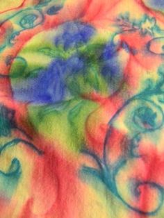 a tie dyed shirt with swirls and flowers on it