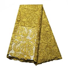 a yellow and white table cloth with an intricate design