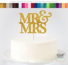 a white cake with gold glitter mr and mrs topper