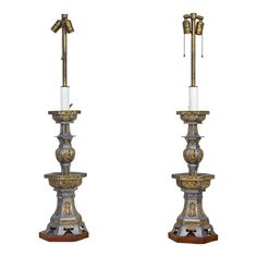 a pair of metal candlesticks sitting on top of each other