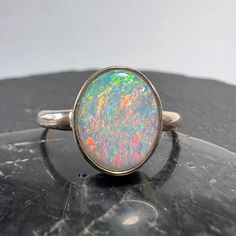 Exceptional Australian opal 14k gold statement ring with nice size oval stone from the Coober Pedy field. Currently US size 7 3/4 (select size at checkout) Australian Opal - 1.38 carats, 10.83mm x 8.75mm x 2.41mm One of kind, hand made. All of our creations are made out of 14K Gold (Yellow, White, Rose) or 925 Sterling Silver, None are filled or electroplated.  All of our stones are Nature-made, therefore some natural flaws may be present. Hand crafted in the We Work Gems Shop in Washington State. Size and weight are approximate. Please feel free to ask any questions. Back to our shop https://www.etsy.com/shop/weworkgems 24D12 Oval Cabochon Opal Ring With Polished Finish, Polished Opal Oval Cabochon Ring, Polished Opal Ring In Oval Cabochon Shape, Opal Oval Cabochon Ring With Polished Finish, Oval Opal Rings With Polished Finish, Oval Ethiopian Opal Moonstone Ring, Classic Ethiopian Opal Ring In Oval Shape, Oval Opal Cabochon Ring, Oval Ethiopian Opal Ring For Anniversary