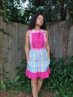 "Custom overall style dress made from 3 secondhand fabrics. The bubblegum pink twill with white hearts was found at a yard sale, fuchsia pink jacquard came from a drapery panel and the lightweight pastel striped cotton was a thrifted nightgown.  The bib is lined, and the straps come over the shoulder and snap into the bib. the skirt has 2 front pockets, is not lined and has a 7\" vintage lime green zipper to close up the dress. Top stitching and bobbin thread are baby pink. model is 5'7\" 143lbs Chest: 36\" Waist: 29\" Hips:40\" Actual measurements: Bib- 13\"H x 12 1/2\"W waistband zipped closed- 31\" skirt length from waistband to bottom hem- 22\" Width of skirt at hip- 45\"" Pink Cotton Dress With Pockets, Cute Sleeveless Pink Pinafore Dress, Cute Pink Sleeveless Pinafore Dress, Cute Pink Pinafore Dress For Spring, Pink Cotton Cute Pinafore Dress, Fitted Pink Dresses With Pockets, Pink Fitted Dresses With Pockets, Pink Fitted Dress With Pockets, Overall Style