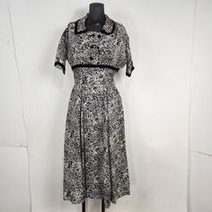 Dress is in good preowned condition, a few light spots of discoloration, otherwise I didn't find any flaws - please see measurements and pictures for details.       Bust: 18",  Length: 46",  Waist: 13".      *Measurements are taken straight across laying flat, not doubled. Black A-line Vintage Dress, 1950s Vintage Pattern Dress For Vintage Fashion, 1950s Style Dresses With Vintage Pattern And Short Sleeves, 1950s Short Sleeve Dress With Vintage Print, 1950s Style Short Sleeve Vintage Dress For Formal Occasions, Classic Short Sleeve Vintage Dress For Vintage Events, Classic Short Sleeve Vintage Dress, Classic Vintage Dress With Short Sleeves For Vintage Events, Formal Lined Vintage Dress