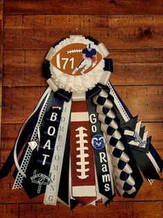 a bunch of ribbons that are on top of a wooden floor with a football decoration