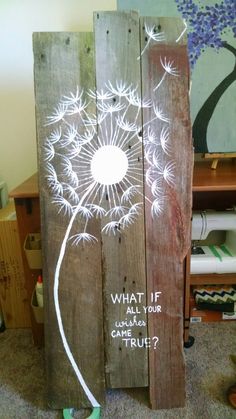 a wooden sign with a dandelion drawn on it