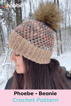 a woman wearing a knitted hat with a pom - pom