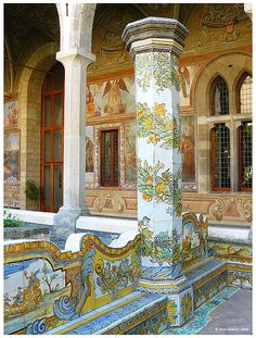 an ornately painted fountain in front of a building