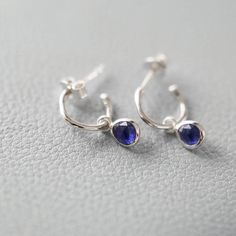 Natural blue Sapphire drops set in Sterling Silver hang from our Mini Hampton Hoop Earrings with a post and butterfly fitting. Sapphire is thought to be the stone of wisdom that will calm the mind."It's been so lovely to work with Sapphires, which are so often just used in engagement rings or alongside diamonds. These earrings are the ultimate every day partner - with jeans and a t-shirt or your favourite dress." - Amelia, Auree Founder. We love every piece of Auree Jewellery and each new owner Sapphire Drop Earrings, Earrings Sapphire, Drop Earrings Silver, Gemstone Drop Earrings, Calm The Mind, Sterling Silver Hoop Earrings, Natural Blue Sapphire, Sapphire Earrings, Engraved Items