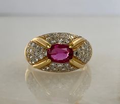 Here is a beautiful 18k yellow gold ruby and diamond ring. This ring will make a great accessory for a night out! Don't miss out! Materials: 18k Yellow gold Stone: 1-Oval Ruby 6.8 x 5mm, 52-RB .75cttw Size: 6.25 Weight: 6.2 grams Sku: 40SB113218COI If you have any questions on this item, please message us! GandDJewelers.etsy.com For ring sizing, please contact us for information. Please note that all of our pieces have been analyzed & identified by a Gemological Institute of America Certifie Formal Yellow Gold Ruby Ring With Pave Setting, Oval Ruby Ring With Pave Setting, Oval Ruby Diamond Ring With Pave Setting, Gold Ruby Ring With Pave Setting, Gold Oval Ruby Ring With Diamond Accents, Ruby And Diamond Ring, Yellow Gold Solitaire, White Gold Sapphire, Gold Stone