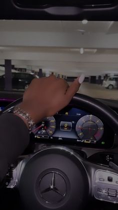 a hand on the steering wheel of a car