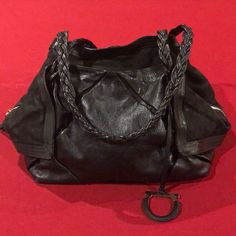 This Black Leather Salvatore Ferragamo Handbag Has A Very Unique Design. The Inside Of The Bag Can Be Filled Up To 12 Inches Across.It Is Made Of Very Soft Leather With Braided Handles. The Inside Has A Large Zipper Pocket, And Two Smaller Pockets. When Not Filled, The Bag Fold In On Itself With The Sides Of The Bag Still Folded Out For The Effect. It Is About 16 Inches Across 8 Inches Tall And Can Expand Up To 12 Inches Across. Salvatore Ferragamo Handbags, Salvatore Ferragamo Bags, Bags Black, Salvatore Ferragamo, Soft Leather, Zipper Pocket, Unique Design, Satchel, Black Leather