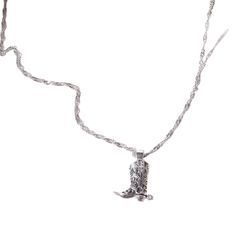 Channel your inner cowgirl spirit with the 'Walkin' Free' Necklace. This captivating piece features a unique cowboy boot pendant, meticulously crafted from high-quality stainless steel with a luxurious 18k gold or sleek silver finish. Lightweight (10g) and hypoallergenic, this necklace offers exceptional comfort for everyday wear. It is a symbol of your adventurous spirit and love for the West. Giddy up for adventure! 18k Gold Plated or Sterling Silver over Stainless Steel Lightweight (10g) & Hypoallergenic Adjustable Chain (40cm + 5cm Extender) Tarnish-Resistant Western Style Necklaces For Western-themed Events, Adjustable Western Metal Necklace, Western Engraved Jewelry For Rodeo, Western Style Engraved Jewelry For Rodeo, Western Metal Jewelry Nickel Free, Silver Metal Western Necklace, Western Silver Metal Jewelry, Western Metal Jewelry For Western-themed Events, Western Style Silver Metal Jewelry