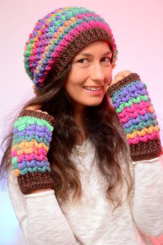 a woman wearing a multicolored knitted hat and mittens