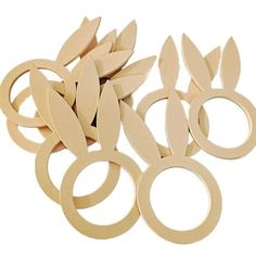 several pairs of scissors are shown on a white background, with one being cut out and the other is made from wood