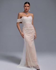 Experience elegance and sophistication with our Off Shoulder Pearl Beaded Gauze Maxi Dress. The stunning off-shoulder design and intricate pearl beading bring a touch of glamour to any occasion. Made with lightweight gauze fabric, this dress is both comfortable and stylish. Elevate your wardrobe with this must-have piece! Our Style No.HT1002 Custom Bead Piece Height - 68.9"/175cm Bust - 34.6"/88cm Waist - 25.6"/65cm Hips - 36.6"/93cm and wears size S Gentle Dry Clean Only About Wholesale/Dropshi Glamorous Off-shoulder Prom Dress With Sweetheart Neckline, Off-shoulder Evening Dress For Wedding Gala, Off-shoulder Gala Evening Dress For Wedding, Gala Wedding Off-shoulder Evening Dress, Off-shoulder Tulle Gown For Evening, Tulle Mother Of The Bride Dress With Sweetheart Neckline, Mother Of The Bride Tulle Dress With Sweetheart Neckline, Elegant Strapless Dress For Gala Banquet, Elegant Strapless Dress For Banquet And Gala