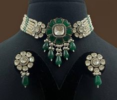 Emerald Polki Green Kundan Victorian Polki set by Sabyasachi showcases antique Indian artistry. The choker features vibrant emerald-green Kundan stones, sparkling Polki diamonds, and Moissanite accents, creating a stunning statement piece. Perfect for adding a touch of regal elegance to any special occasion. *𝐏𝐑𝐎𝐃𝐔𝐂𝐓 𝐃𝐄𝐓𝐀𝐈𝐋* * Material: Brass * Plating: Gold Plated * Stone: Semi Precious Kundan & Polki. *𝐃𝐈𝐒𝐂𝐋𝐀𝐈𝐌𝐄𝐑* Product color may slightly vary due to photographic light Elegant Ceremonial Choker With Meenakari, Traditional Meenakari Choker For Formal Occasions, Traditional Heavy Choker For Formal Occasions, Elegant Green Cutdana Choker, Heavy Traditional Kundan Necklace For Formal Occasions, Traditional Festive Choker For Formal Occasions, Traditional Formal Choker For Festivals, Traditional Festive Formal Choker, Formal Traditional Choker