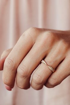 a woman's hand with a gold ring on it