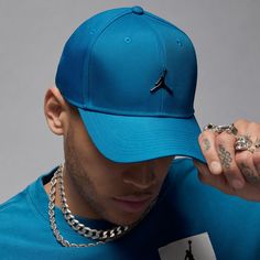 Jumpman matches with a Jumpman, so the Jordan Rise Cap Structured Curved Brim Metal Jumpman Strapback Cap will look perfect with the rest of your gear. Because it has minimal color differentiation, it'll match perfectly with a number of outfits, even non-Jordan ones. The strapback closure allows you to find the right size without the nuisance of your hair getting stuck in the holes. Features small, embroidered Jumpman logo centered on the front. Strapback (adjustable). Curved bill for classic lo Functional Blue Baseball Cap For Sports, Functional Blue Baseball Cap With Curved Brim, Functional Blue Snapback Hat, Functional Blue Curved Brim Baseball Cap, Blue Sports Hat With Curved Visor, Sporty Blue Baseball Cap For Sports, Blue Sporty Baseball Cap For Sports, Functional Blue Baseball Cap, Functional Blue Sports Hat