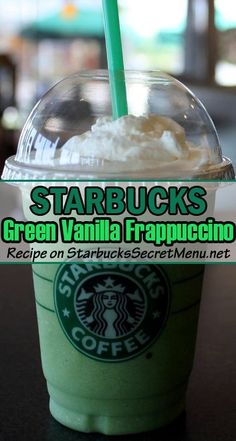 starbucks's green vanilla frappuccino is on the table with its straw in it